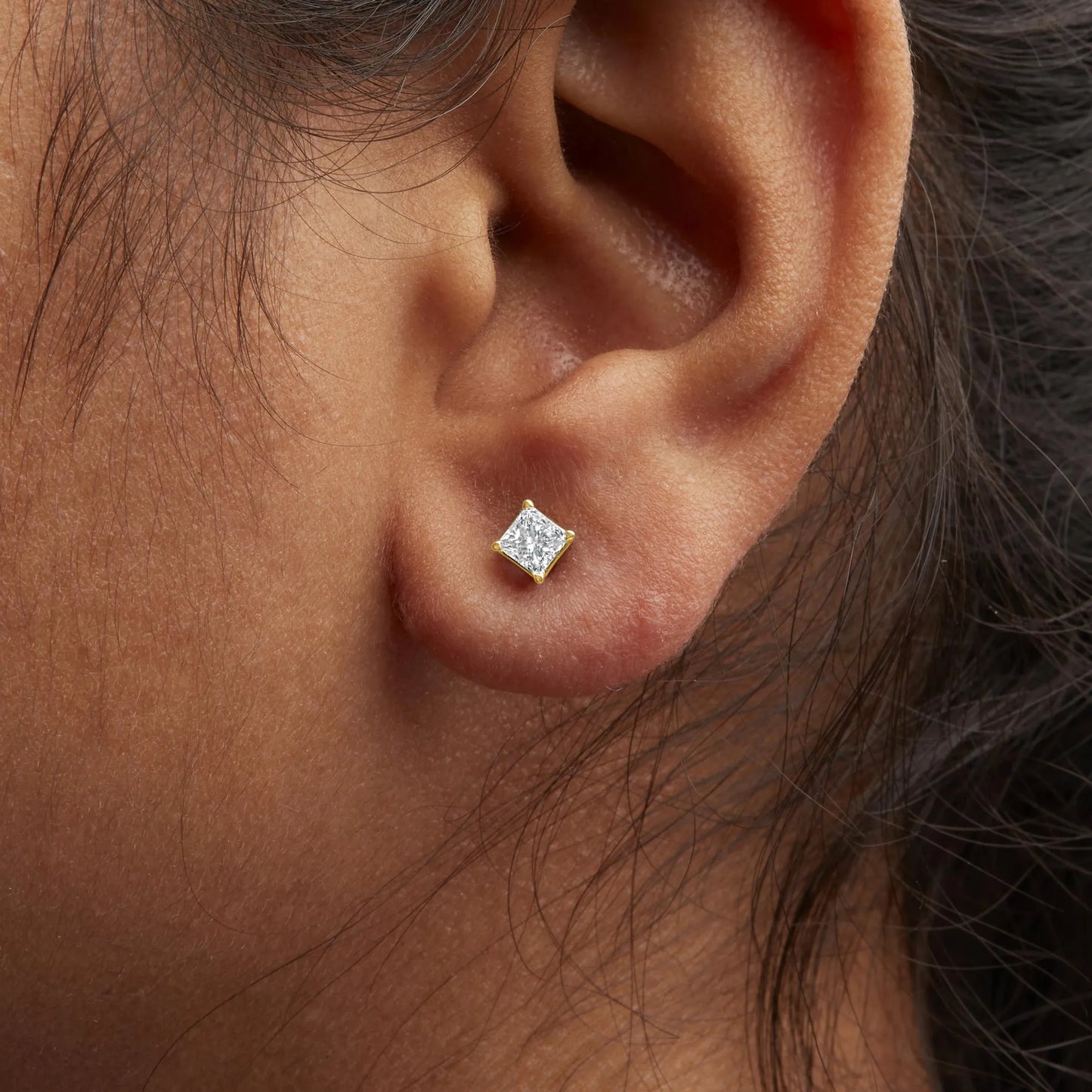Princess-Cut Square Diamond 4-Prong Solitaire Stud Earrings worn by a model