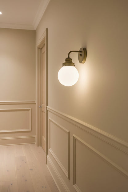 One Light Gold Wall Sconce with Round Glass Shade