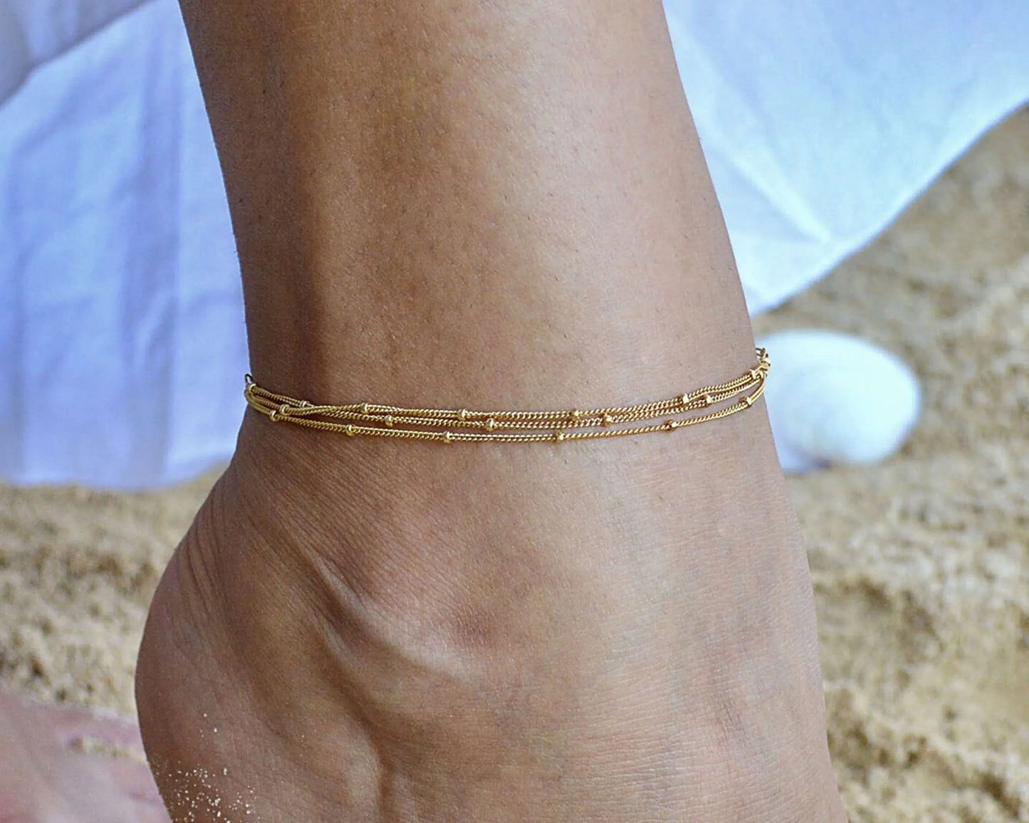Gold Multi Chain Ankle Bracelet worn by a model